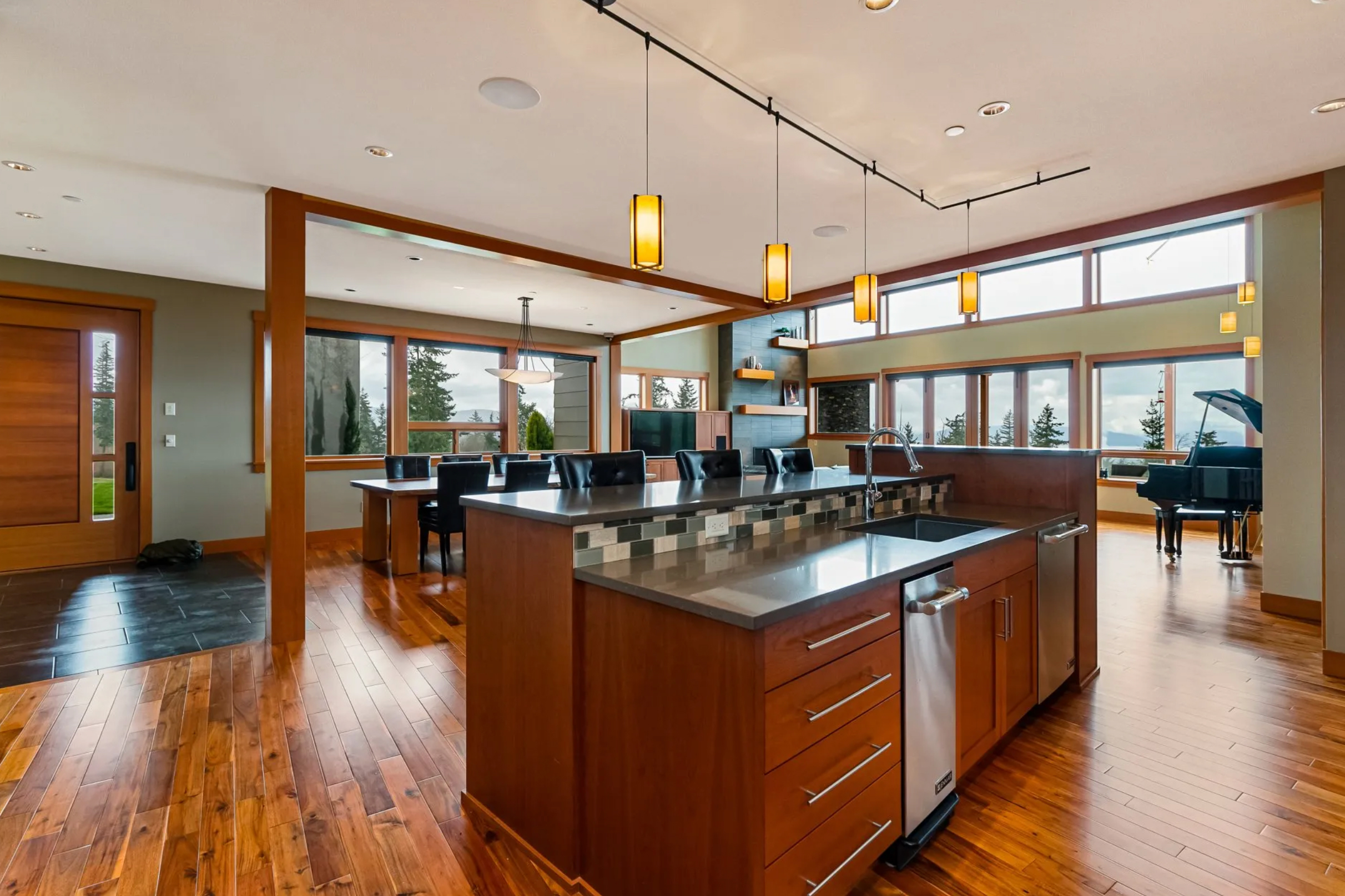 Residential kitchen with pendant, recessed and track lighting.