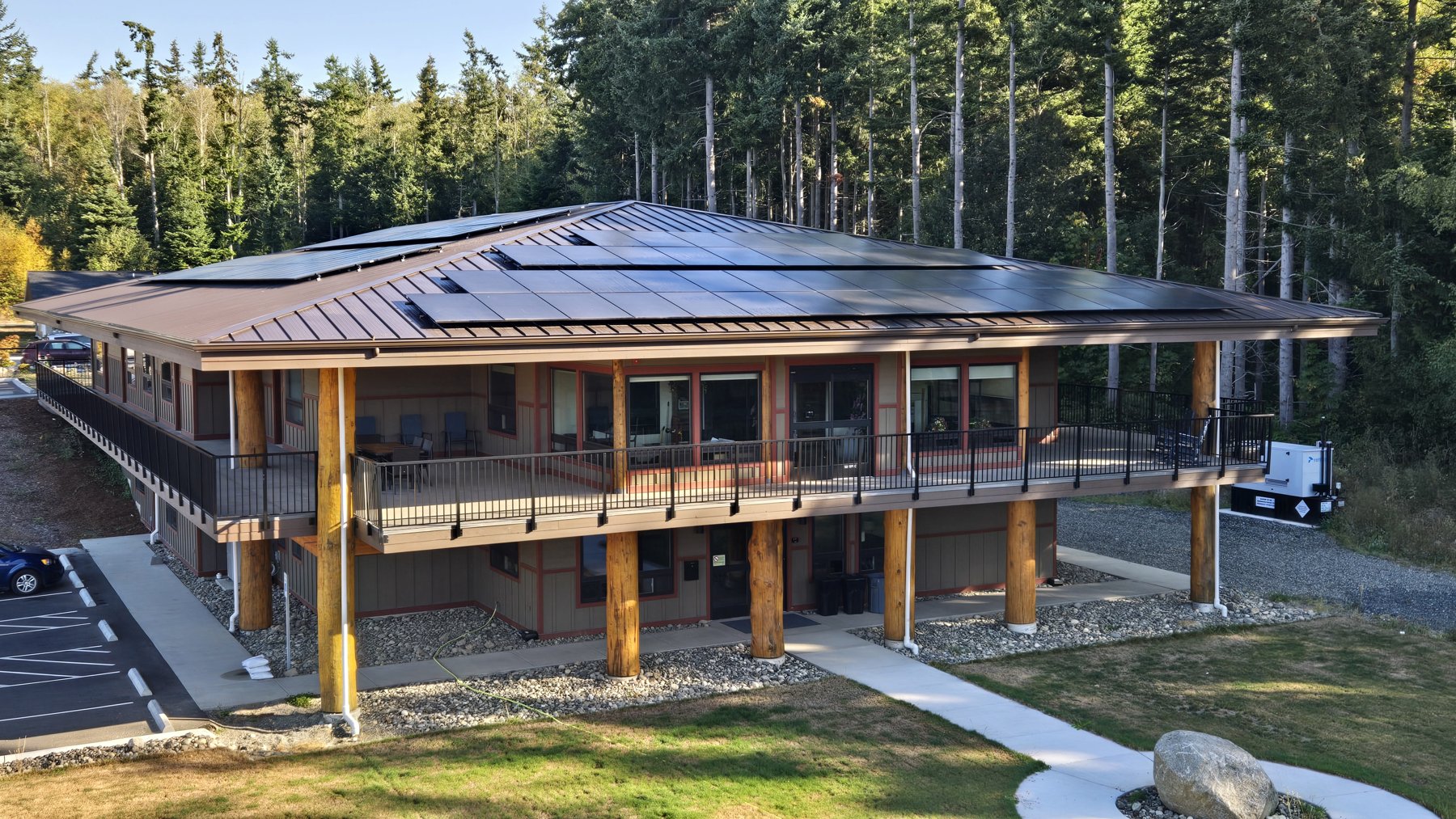 lummi-solar-installation Rooftop solar installation at the Lummi Elder Care Center, with timber columns and a covered balcony.